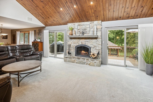 living room featuring carpet, a stone fireplace, and high vaulted ceiling