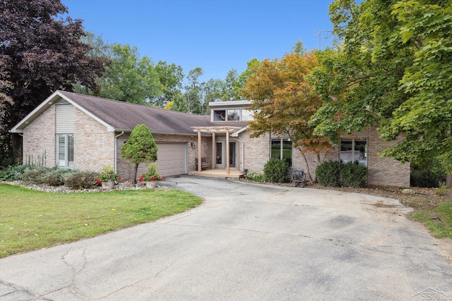 view of front of house with a garage and a front lawn