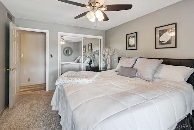 bedroom featuring ceiling fan, a closet, and carpet flooring