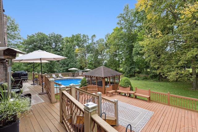 wooden terrace featuring a gazebo and a yard