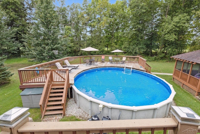 view of pool featuring a deck and a yard