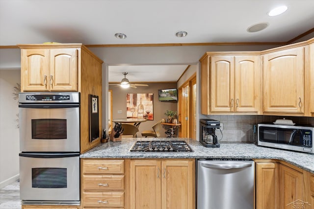 kitchen featuring ceiling fan, light stone counters, light brown cabinets, and stainless steel appliances