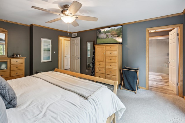 carpeted bedroom with ceiling fan and ornamental molding