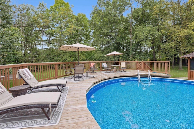 view of swimming pool with a wooden deck