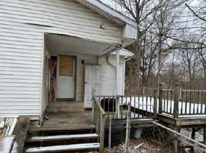 doorway to property featuring a wooden deck