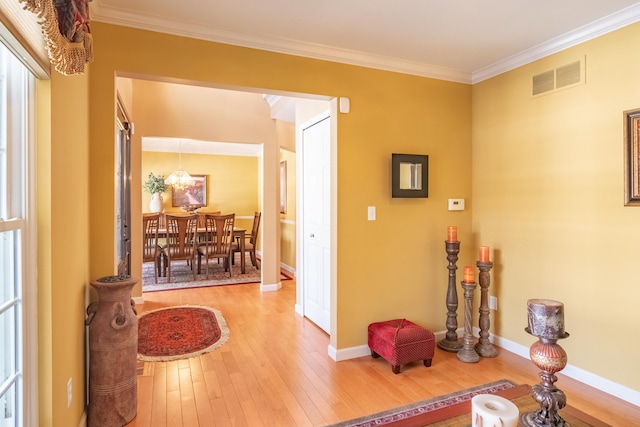 interior space with crown molding and hardwood / wood-style floors