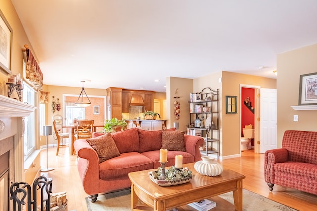 living room with light wood-type flooring and a premium fireplace