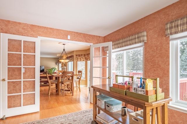 dining room featuring hardwood / wood-style flooring and french doors