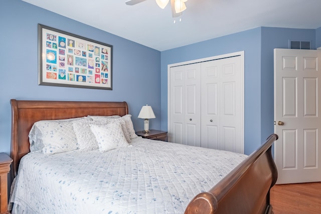 bedroom featuring hardwood / wood-style floors, a closet, and ceiling fan