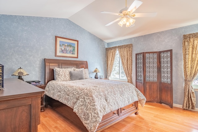 bedroom featuring light wood-type flooring, vaulted ceiling, and ceiling fan