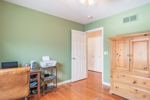 office area with light wood-type flooring and ceiling fan