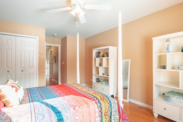 bedroom with ceiling fan, light hardwood / wood-style floors, and a closet