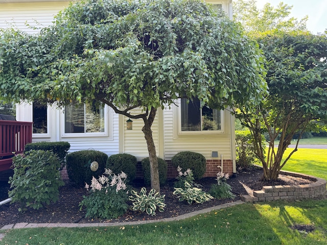 view of side of home with a lawn