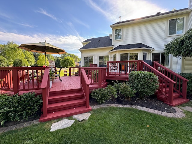 wooden deck featuring a yard