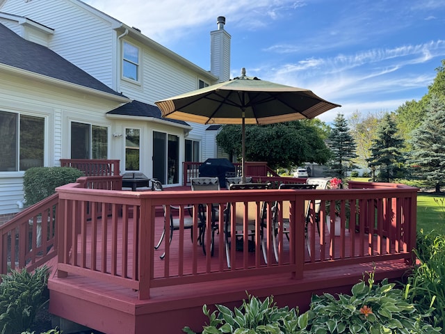 wooden terrace with a grill