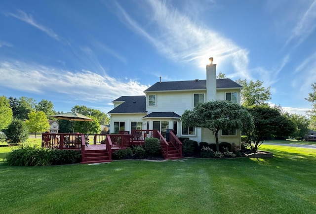 rear view of property with a gazebo, a lawn, and a wooden deck