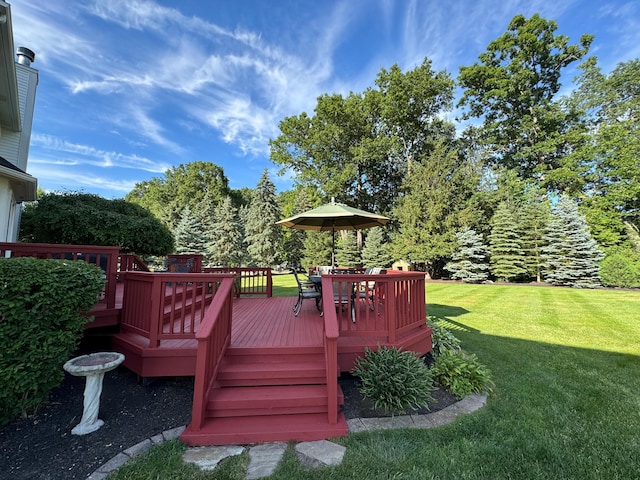 wooden deck featuring a yard