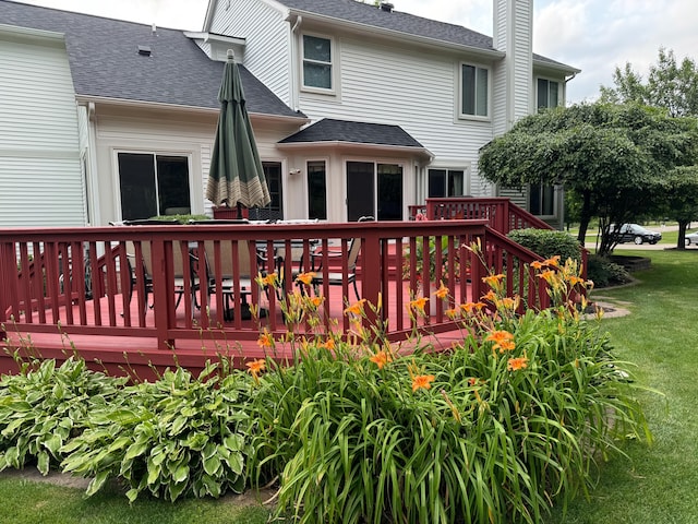 wooden deck featuring a yard