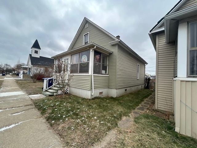 view of side of home featuring a yard