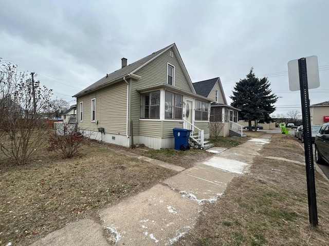 view of home's exterior featuring a sunroom