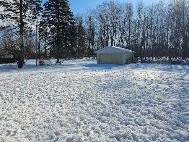 3593 Southern Dr, Hart, MI 49420 - yard layered in snow featuring an outdoor structure and a garage