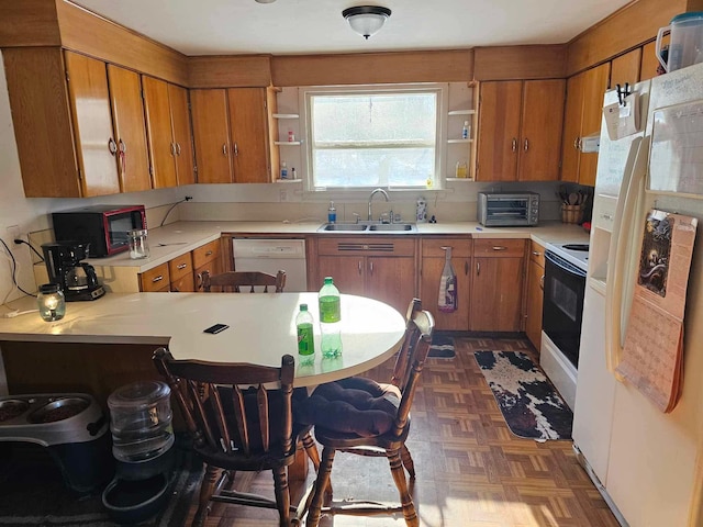 3593 Southern Dr, Hart, MI 49420 - kitchen featuring sink, white appliances, kitchen peninsula, and dark parquet floors