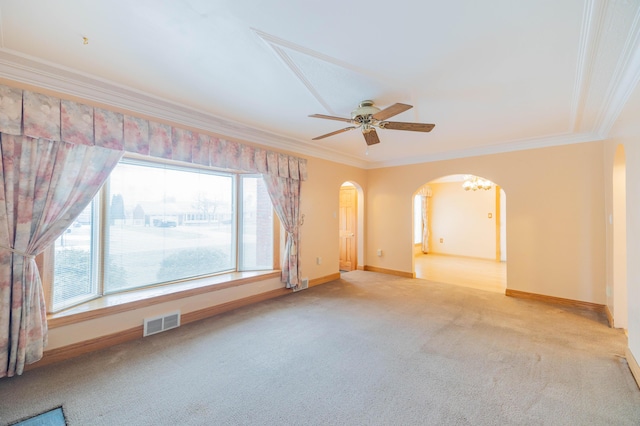 carpeted spare room with ceiling fan and crown molding