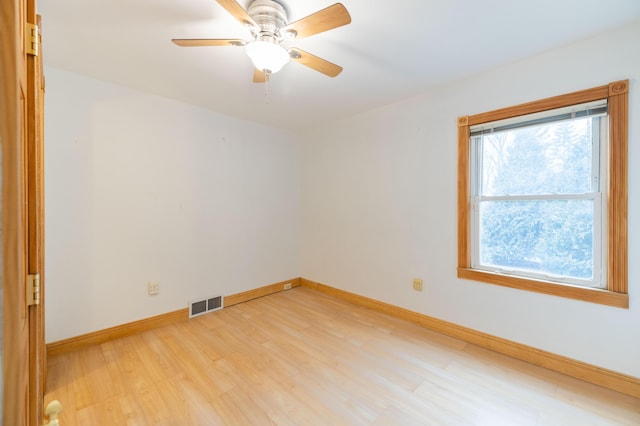 empty room featuring ceiling fan and light wood-type flooring