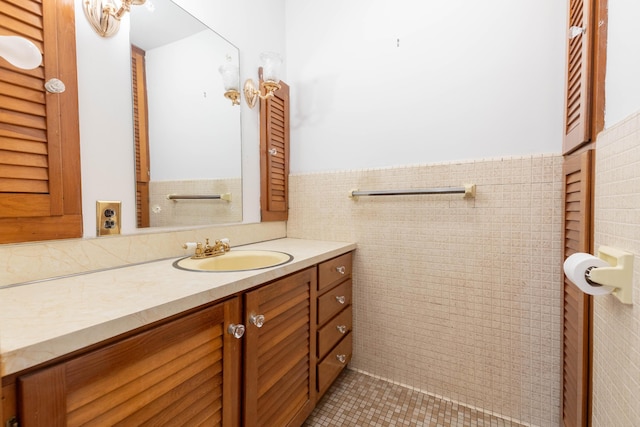 bathroom with tile patterned flooring, tile walls, and vanity