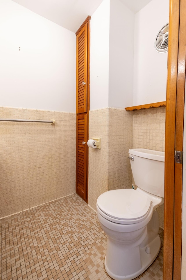 bathroom featuring tile walls, toilet, and tile patterned flooring