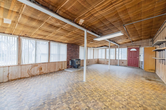 basement with plenty of natural light and a wood stove