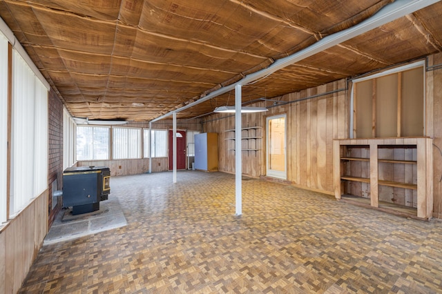 basement with dark parquet floors and a wood stove