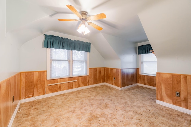 additional living space featuring ceiling fan, light carpet, and vaulted ceiling