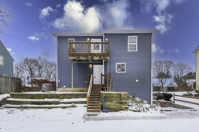 view of snow covered rear of property