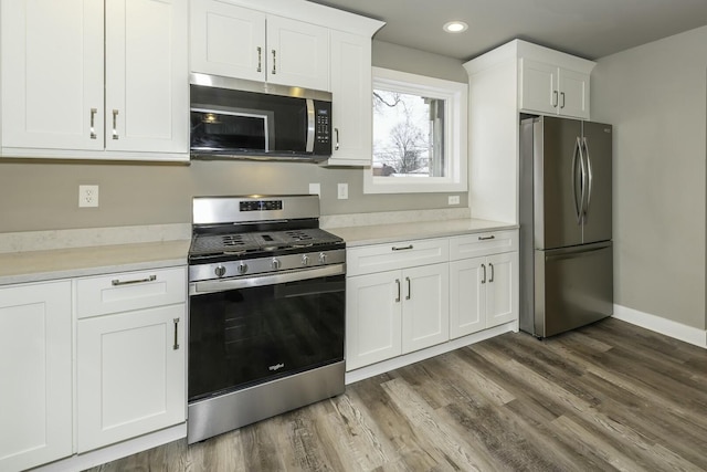 kitchen featuring white cabinets, dark hardwood / wood-style floors, and stainless steel appliances