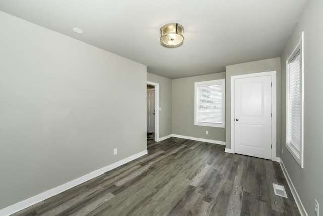 unfurnished bedroom with dark wood-type flooring