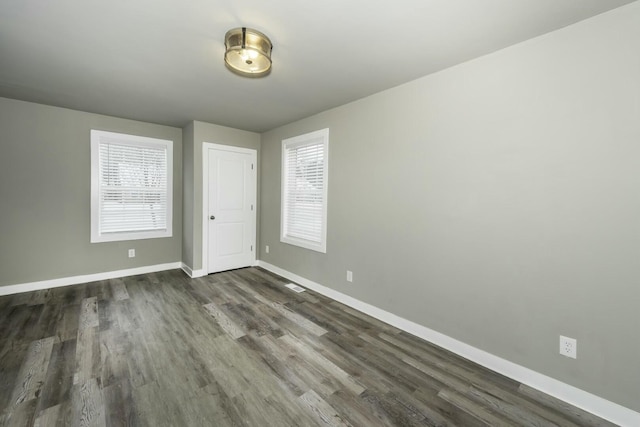 spare room featuring dark hardwood / wood-style flooring