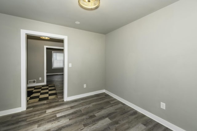 empty room with dark hardwood / wood-style flooring