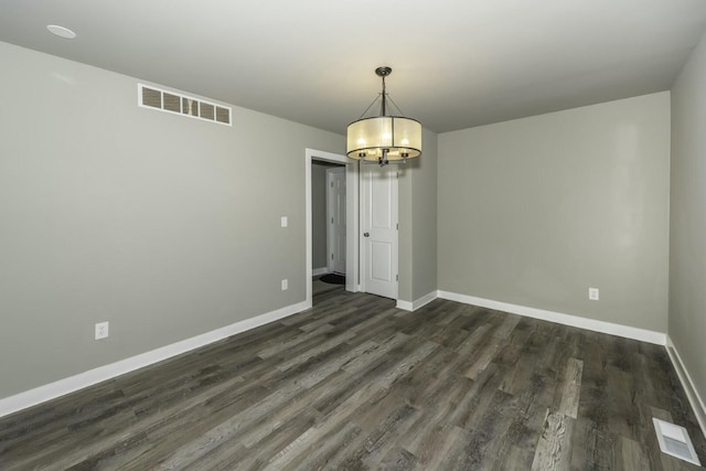 unfurnished dining area with dark hardwood / wood-style floors and a notable chandelier