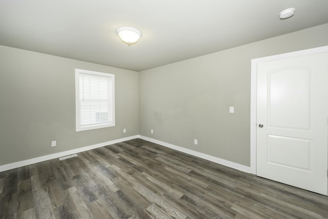 empty room featuring dark hardwood / wood-style flooring