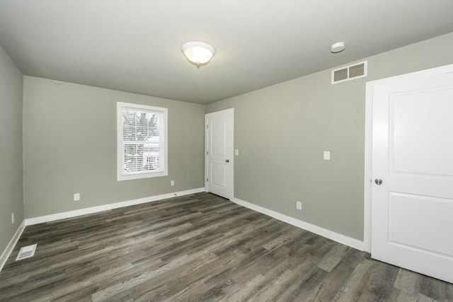 unfurnished room featuring dark hardwood / wood-style flooring