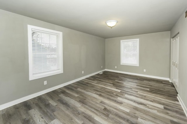 empty room with dark wood-type flooring