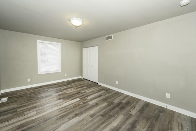 spare room featuring dark hardwood / wood-style flooring