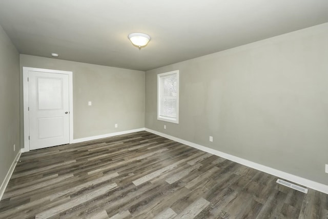 unfurnished room featuring dark hardwood / wood-style flooring