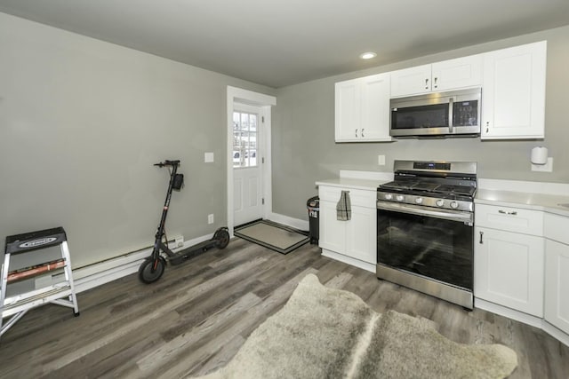 kitchen featuring dark wood-type flooring, white cabinets, and appliances with stainless steel finishes