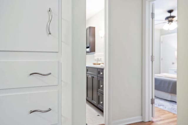 bathroom featuring ceiling fan, vanity, and hardwood / wood-style flooring