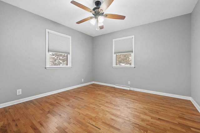 unfurnished room featuring ceiling fan, a healthy amount of sunlight, light hardwood / wood-style floors, and a baseboard radiator