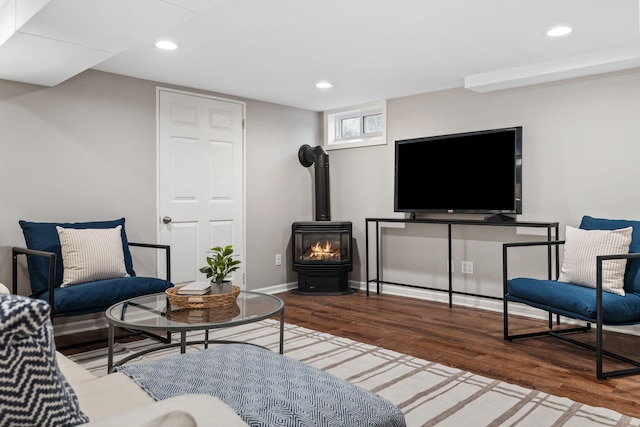 living room featuring a wood stove and hardwood / wood-style flooring