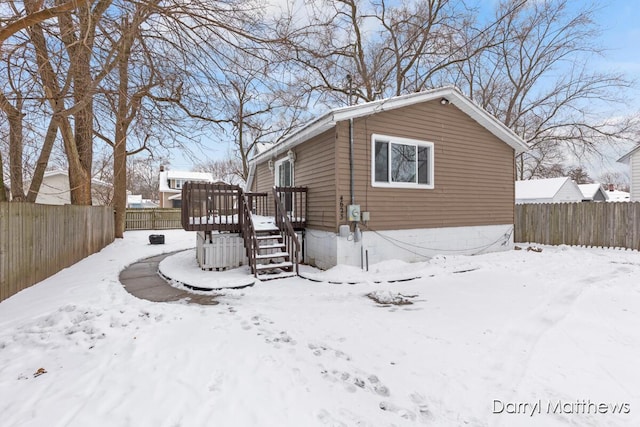 view of snow covered exterior featuring a wooden deck