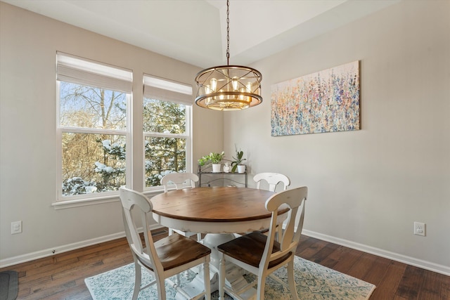 dining area featuring dark hardwood / wood-style flooring and an inviting chandelier